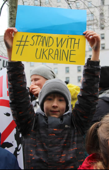 Child with &lsquo;stand with Ukraine&rsquo; banner